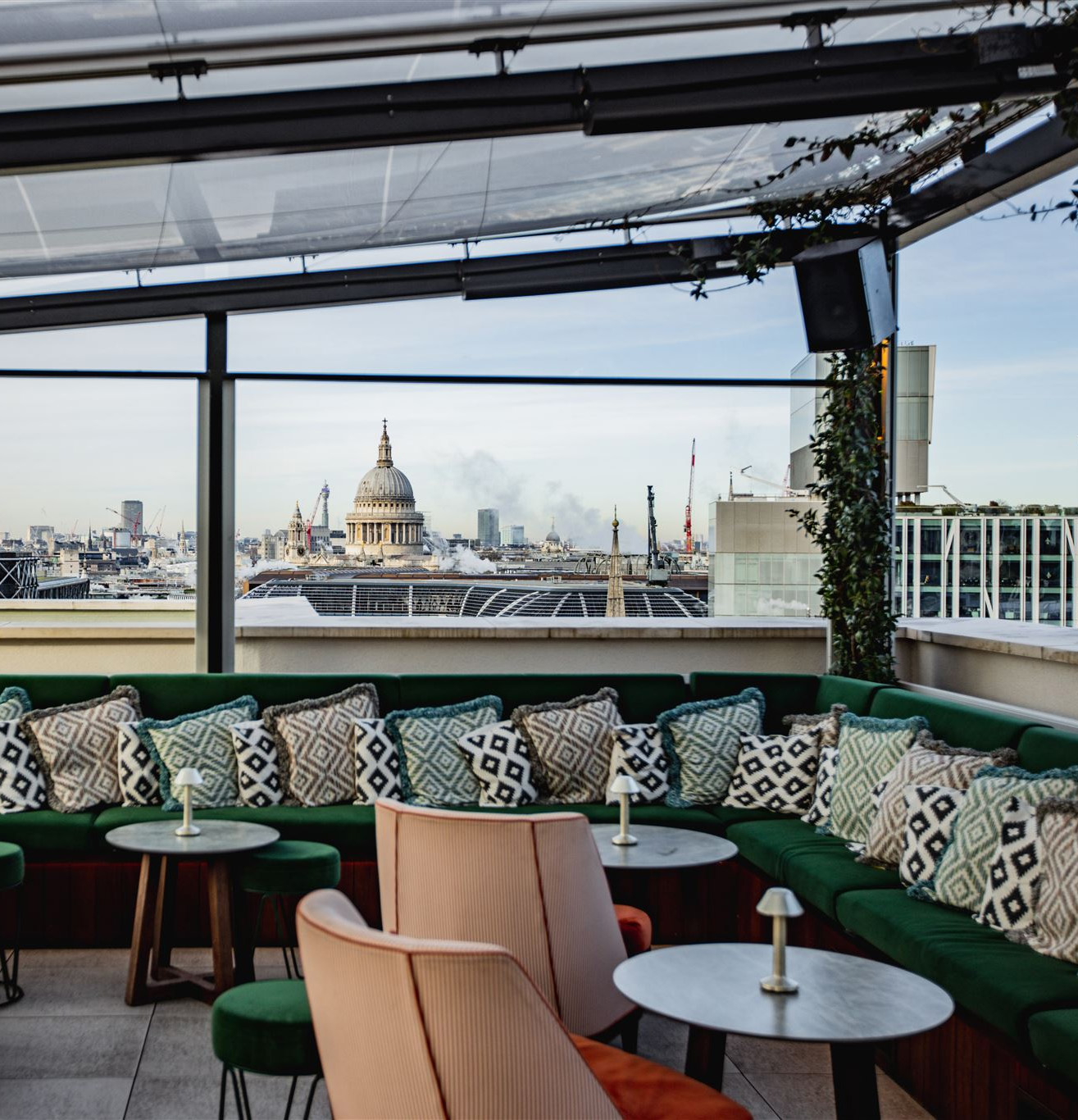 ETM Weddings - The Wagtail sheltered dining area with Green velvet couches overlooking St Paul's Iconic dome.